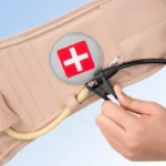 decompression belt hand pump connection and medical cross logo close up